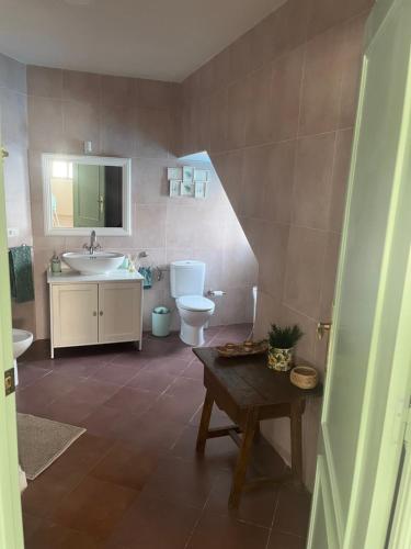 a bathroom with a sink and a toilet and a sink at El Refugio de Navalcuervo 