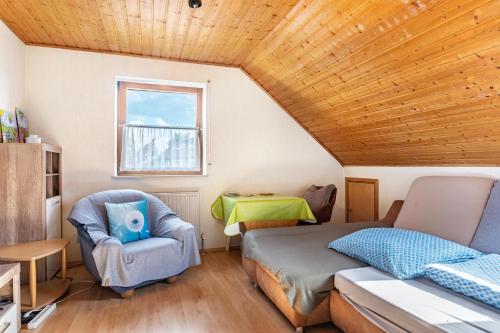 a bedroom with a bed and a chair and a table at Work&Travel-Pension Tobias in Selb