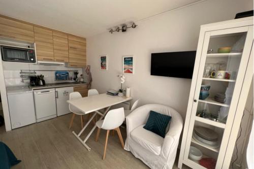 a small kitchen with a table and chairs in a room at Flat With Swimming Pool Close To The Beach in Arcachon