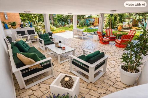 a patio with a bunch of chairs and tables at Residence Casa Pineta in Principina a Mare