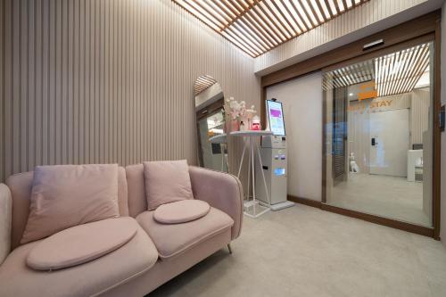 a living room with a couch in a store at Just Stay Hotel in Seoul