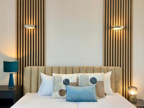 a bedroom with a bed with blue and white pillows at Angel MINT Apartment - FREE PARKING - Balcony in Krakow