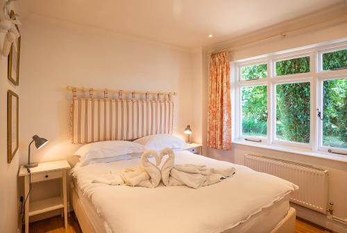 a bedroom with a bed with towels on it at The Cottage Hankerton Priory in Hankerton