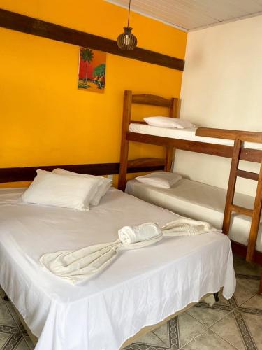 two beds in a room with two bunk beds at Pico das Praias Suites in Itacaré