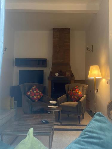 a living room with two chairs and a table at Lux Villa in Casablanca