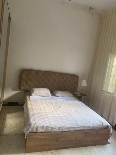 a bedroom with a bed with a wooden headboard at Lux Villa in Casablanca