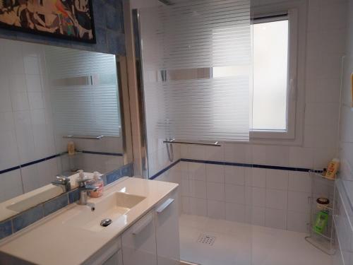 a white bathroom with a sink and a mirror at Vallon des auffes - proche mer in Marseille