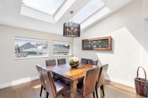 a dining room with a wooden table and chairs at Family-Friendly 3BR Home in Vancouver