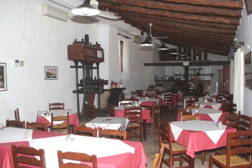 a restaurant with tables and chairs with red table cloth at Oasis Guesthouse in Chania Town