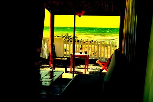 a view of the beach from a room with a window at Guerrera Rice Paddy Villas in Mambajao
