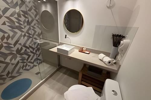 a bathroom with a toilet and a sink and a shower at Hotel Residence in Rio de Janeiro