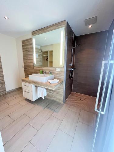 a bathroom with a sink and a mirror at Hotel-Restaurant Krüger in Grafhorst