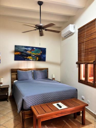 a bedroom with a bed and a ceiling fan at Bel Air/Sutton in San Juan del Sur
