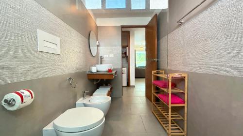 a bathroom with a white toilet and a sink at Experience the Pool View Dream at Estrella Dominicus in Bayahibe
