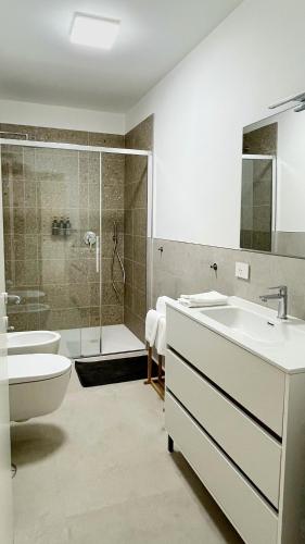 a bathroom with a tub and a sink and a shower at Il Porticciolo in Lezzeno