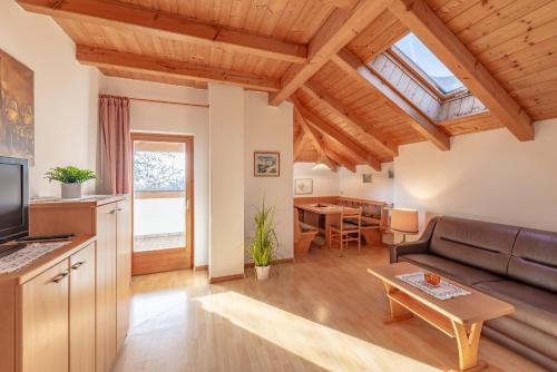 a living room with a couch and a table at Apartments Haus Weinberg in Caldaro
