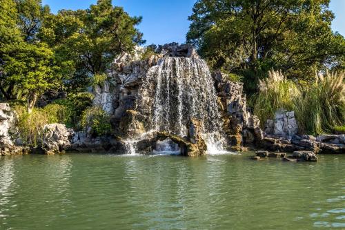 a waterfall in the middle of a pond at Xijiao State Guest Hotel in Shanghai