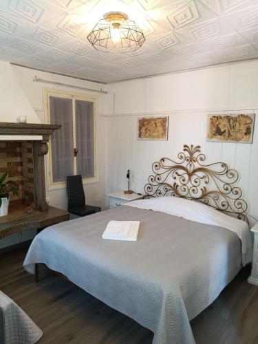a bedroom with a large bed and a chandelier at La Casa di Giovanni B&B in Romano D'Ezzelino