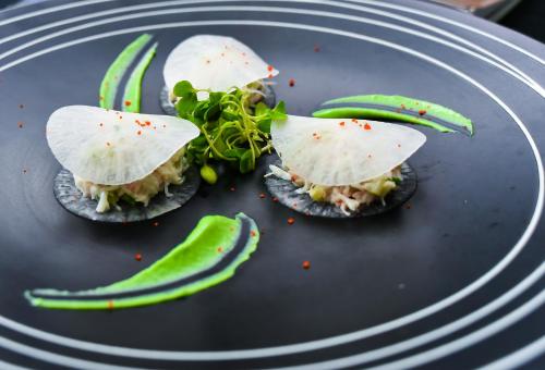a plate of food with avocado and a sandwich at Xijiao State Guest Hotel in Shanghai
