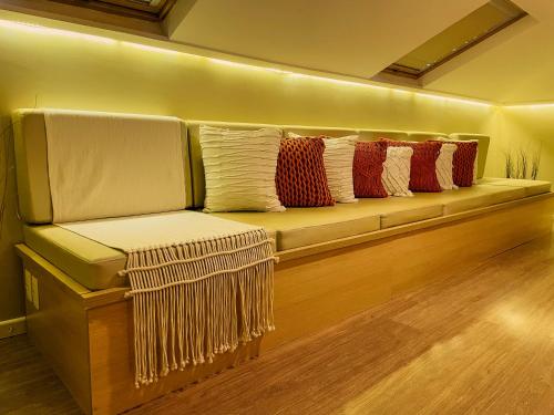 a bench with pillows on it in a room at Sea Paradise Hospedagem in Fernando de Noronha