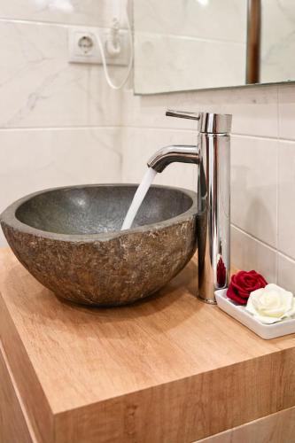 a bathroom sink with a stone bowl on a counter at Apartamento en Montserrat- Montserrat Paradise Apartament in Monistrol