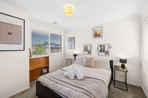 a bedroom with a bed with two towels on it at Beach Living Bliss in Torquay