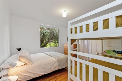 a bedroom with a bunk bed and a ladder at Blue Surf - BYO Linen in Apollo Bay