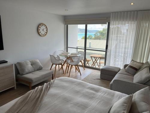 a bedroom with a bed and a table and chairs at Bay View Motel - Sunrise in Lorne