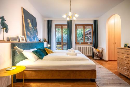 a bedroom with a large bed and a yellow table at Reihenvilla Ambachgasse in Caldaro