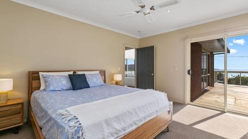 a bedroom with a large bed and a balcony at Majestic Views in Marengo