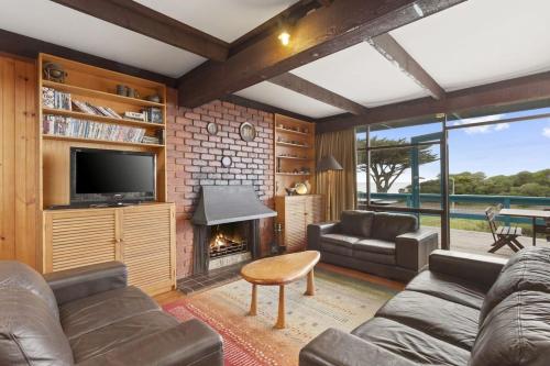 a living room with a couch and a fireplace at Aqua Blue in Apollo Bay