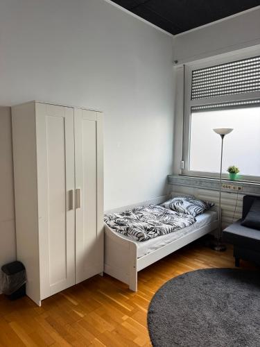 a white room with a bed and a window at City Room 2 Stuttgart-Mitte in Stuttgart