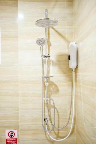 a shower in a bathroom with a phone on the wall at Good Pool Villa Luxury in Ban Hui Yai Muk