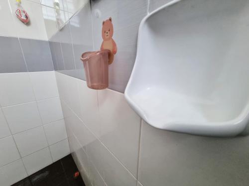 a bathroom with a toilet and a trash can at HomeStay with Serene Surrounding in Nibung Tebal