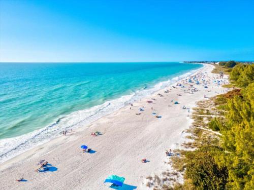 an overhead view of a beach with people and umbrellas at Family Tides in Holmes Beach