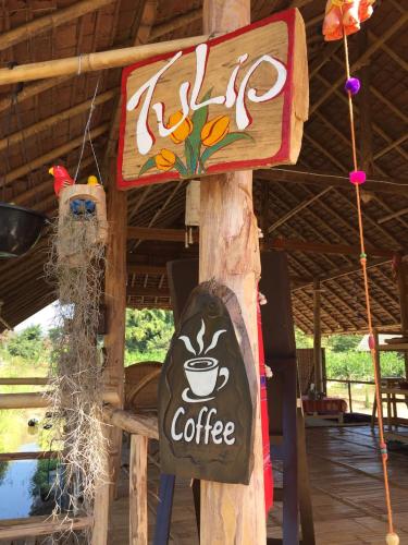 a sign for a coffee shop with a bear on it at Tulip Resort Pai in Pai