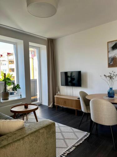 a living room with a couch and a table at Cozy Apartment with Castle view in Staré Mesto