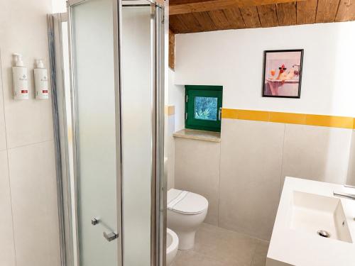 a bathroom with a toilet and a sink at Podere Cafasso Country House in Paestum