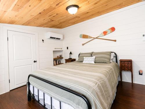 a bedroom with a bed with a wooden ceiling at Cameron's Cottage at The Lake in Tallassee