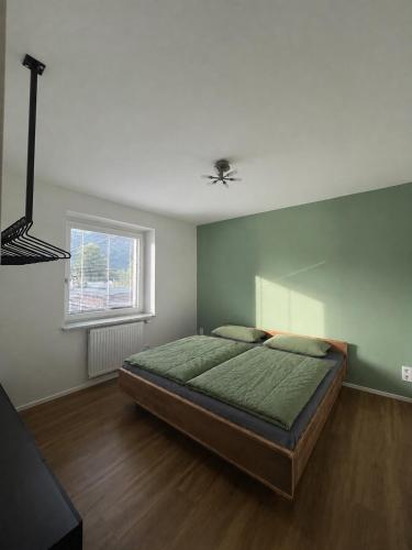 a bedroom with a bed and a ceiling fan at Appartement Kochen in Döbriach