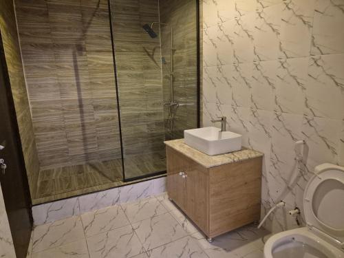 a bathroom with a shower and a sink and a toilet at Al-ihsan Metro Hotel in Kaduna