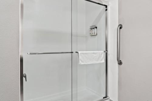 a shower with a glass door in a bathroom at Holiday Inn Express Hotel & Suites Marion by IHG in Marion
