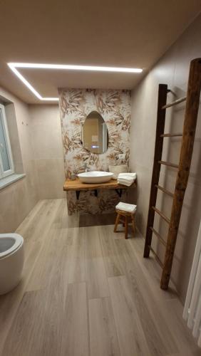 a bathroom with a sink and a mirror at San Lorenzo Suite in Tigliole