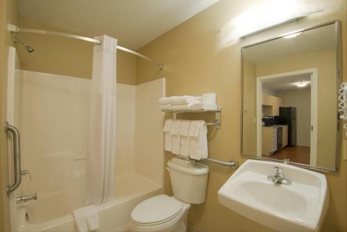 a bathroom with a toilet and a sink and a shower at Candlewood Suites Sheridan by IHG in Sheridan