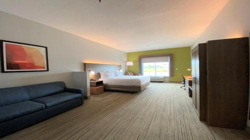 a hotel room with a bed and a couch at Holiday Inn Express Hotel & Suites Somerset Central by IHG in Somerset