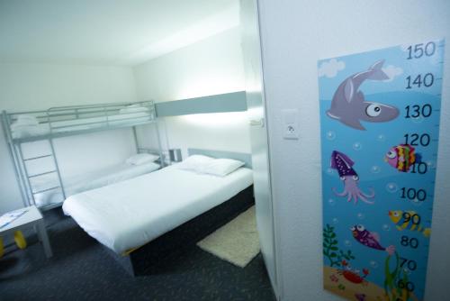 a bedroom with a bed with a fish on the wall at hôtel QUICK Palace Tours Nord in Tours