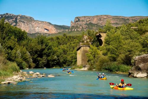 a group of people rafting down a river at Casa Felisa Pirineo Aragonés in Santa Eulalia de Gállego