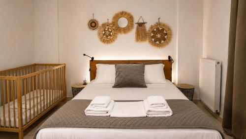a bedroom with a bed with towels on it at Deodonum Luxury Apartments in Heraklio