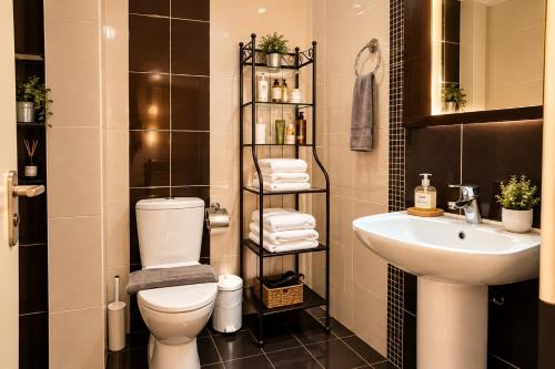 a bathroom with a toilet and a sink at Deodonum Luxury Apartments in Heraklio