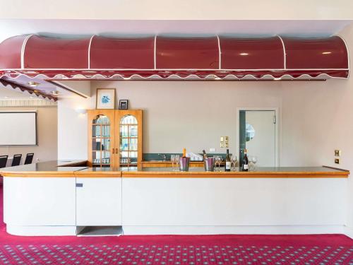 a kitchen with a counter with a red and white at Wairakei Resort Taupo in Taupo
